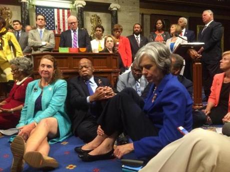 Representatives Katherine Clark (right, in blue), and John Lewis (center, in suit), a longtime civil rights leader, led a Democratic sit-in on the House floor Wednesday.
